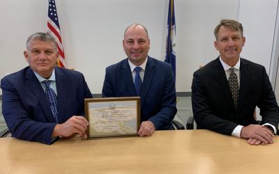 Men hold plaque